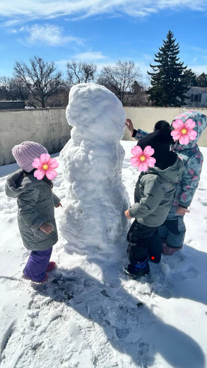 Building a snowman during outdoor play
